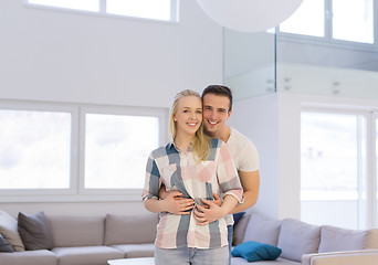 Image showing couple hugging in their new home