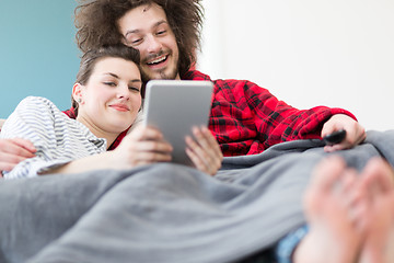 Image showing couple relaxing at  home with tablet computers