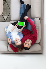 Image showing couple relaxing at  home with tablet computers