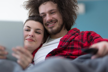 Image showing couple relaxing at  home with tablet computers