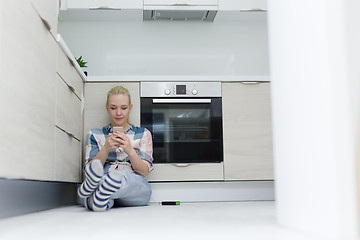 Image showing young women using mobile phone at home