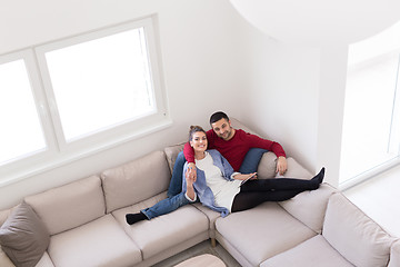 Image showing couple relaxing at  home with tablet computers