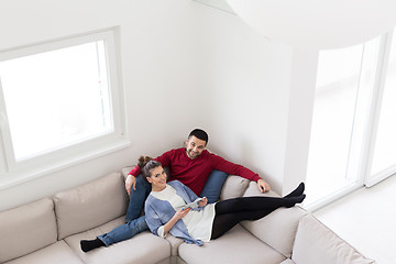 Image showing couple relaxing at  home with tablet computers