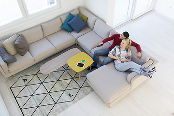 Image showing Young couple on the sofa watching television