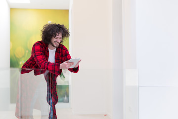 Image showing young freelancer using tablet computer