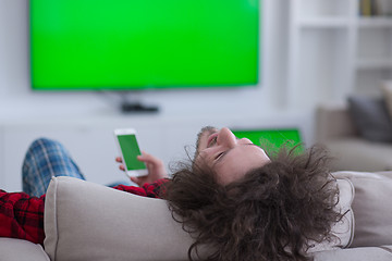 Image showing young man in bathrobe enjoying free time