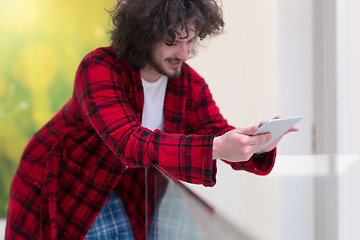 Image showing young freelancer using tablet computer