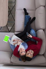 Image showing Young couple on the sofa watching television top view