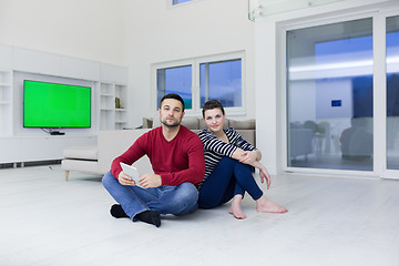 Image showing Young Couple using digital tablet on the floor