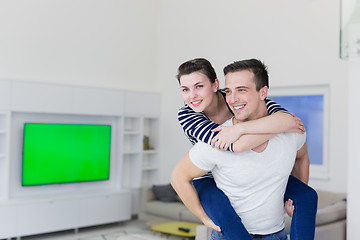 Image showing handsome man piggybacking his girlfriend