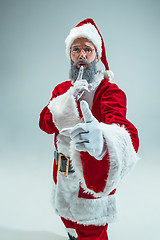 Image showing Funny guy in christmas hat. New Year Holiday. Christmas, x-mas, winter, gifts concept.