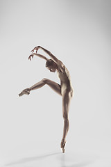 Image showing Ballerina. Young graceful female ballet dancer dancing at studio. Beauty of classic ballet.