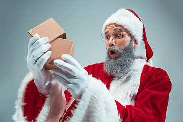 Image showing Funny guy in christmas hat. New Year Holiday. Christmas, x-mas, winter, gifts concept.