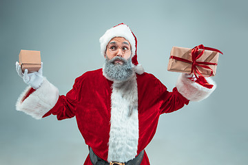 Image showing Funny guy in christmas hat. New Year Holiday. Christmas, x-mas, winter, gifts concept.