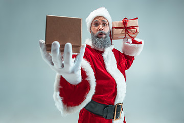 Image showing Funny guy in christmas hat. New Year Holiday. Christmas, x-mas, winter, gifts concept.