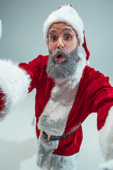 Image showing Funny guy in christmas hat. New Year Holiday. Christmas, x-mas, winter, gifts concept.