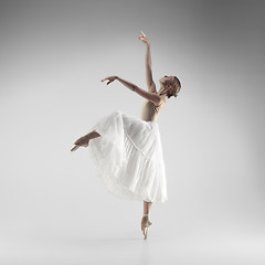 Image showing Ballerina. Young graceful female ballet dancer dancing at studio. Beauty of classic ballet.