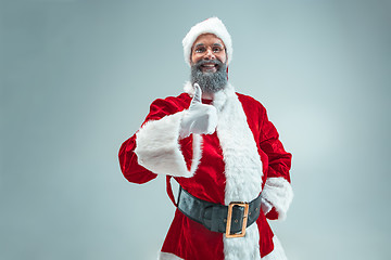 Image showing Funny guy in christmas hat. New Year Holiday. Christmas, x-mas, winter, gifts concept.