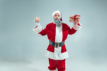 Image showing Funny guy in christmas hat. New Year Holiday. Christmas, x-mas, winter, gifts concept.