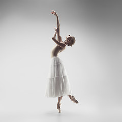 Image showing Ballerina. Young graceful female ballet dancer dancing at studio. Beauty of classic ballet.