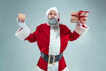 Image showing Funny guy in christmas hat. New Year Holiday. Christmas, x-mas, winter, gifts concept.