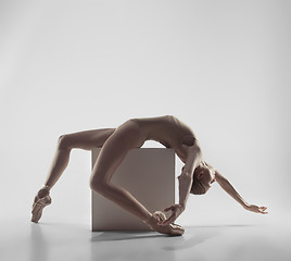 Image showing Ballerina. Young graceful female ballet dancer dancing at studio. Beauty of classic ballet.