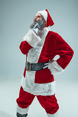 Image showing Funny guy in christmas hat. New Year Holiday. Christmas, x-mas, winter, gifts concept.