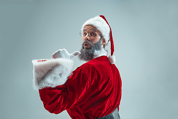 Image showing Funny guy in christmas hat. New Year Holiday. Christmas, x-mas, winter, gifts concept.