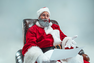 Image showing Funny guy in christmas hat. New Year Holiday. Christmas, x-mas, winter, gifts concept.