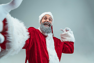 Image showing Funny guy in christmas hat. New Year Holiday. Christmas, x-mas, winter, gifts concept.