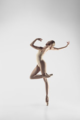 Image showing Ballerina. Young graceful female ballet dancer dancing at studio. Beauty of classic ballet.