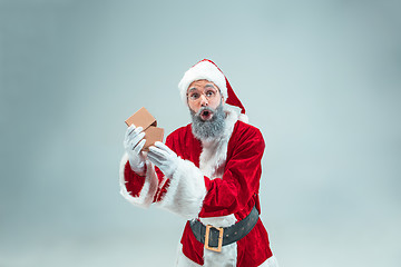 Image showing Funny guy in christmas hat. New Year Holiday. Christmas, x-mas, winter, gifts concept.