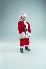 Image showing Funny guy in christmas hat. New Year Holiday. Christmas, x-mas, winter, gifts concept.