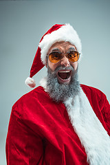 Image showing Funny guy in christmas hat. New Year Holiday. Christmas, x-mas, winter, gifts concept.