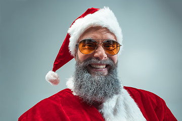 Image showing Funny guy in christmas hat. New Year Holiday. Christmas, x-mas, winter, gifts concept.