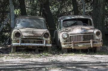 Image showing Two old, rusted, abandoned cars.