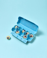 Image showing Paper tray with eyeballs on a pastel blue background.