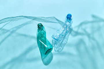 Image showing Marine waves from shadows of plastic foil with floating bottles.