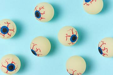 Image showing Halloween pattern eyeballs on a pastel blue background.