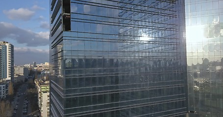 Image showing Glass office building and view of the modern city with passing cars and railway. 4K video, 240fps, 2160p.