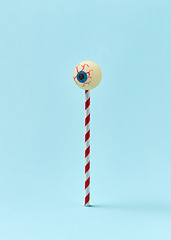 Image showing Human eyeball on a plastic straw as a candy.