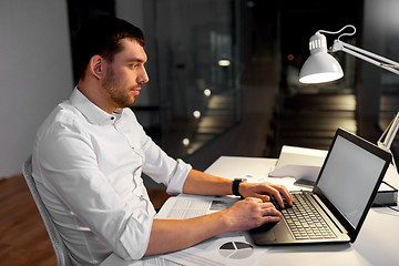 Image showing businessman with laptop working at night office