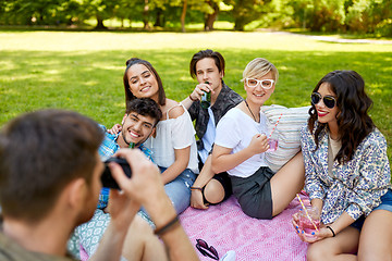 Image showing friends with drinks photographing at summer picnic