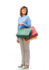 Image showing senior woman with shopping bags isolated on white