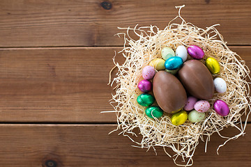 Image showing chocolate eggs and candies in straw nest