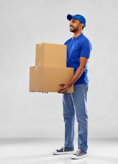 Image showing happy indian delivery man with parcel boxes