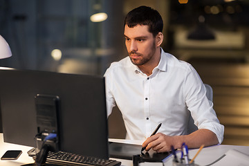 Image showing designer with computer and pen tablet at office