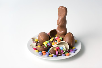 Image showing chocolate bunny, eggs and candies on white plate