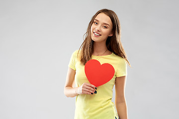 Image showing smiling teenage girl with red heart