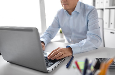 Image showing close up of businessman working with laptop